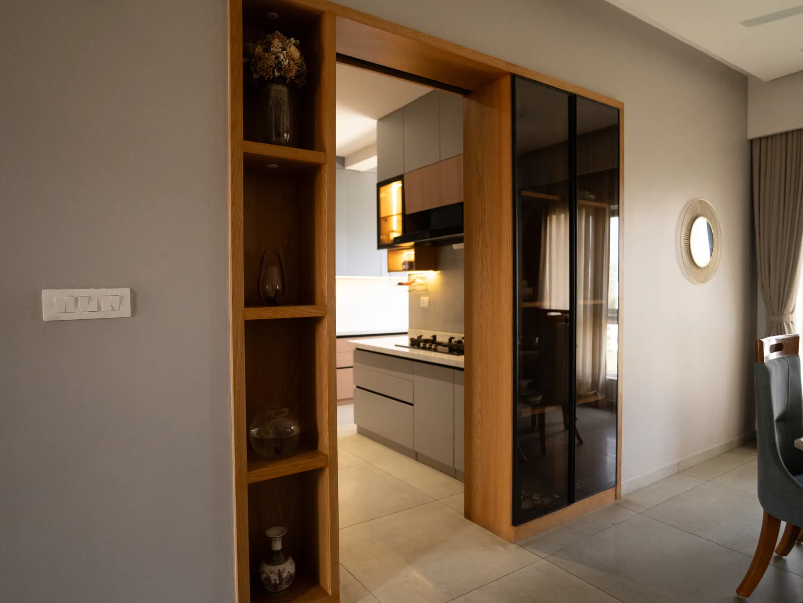 Kitchen entrance with oak frame and black glass door — Amlan's Residence